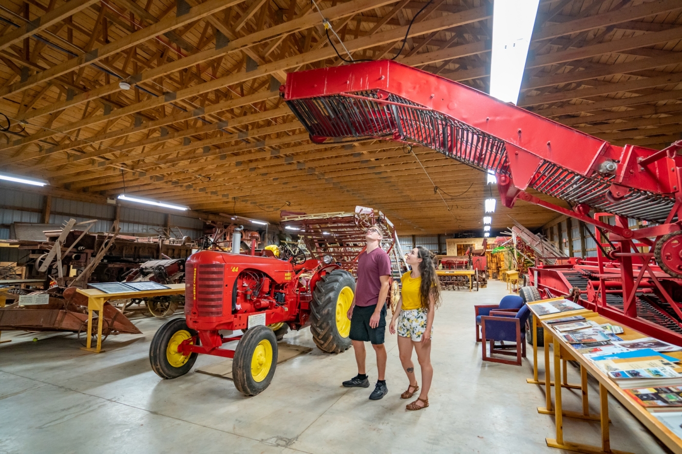 Two people tour Canadian Potato Museum machinery exhibit